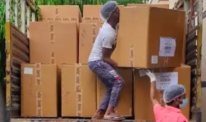 Workers loading donation boxes in truck PPE Kits Donation Drive Tring